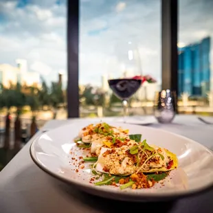 a plate of food and a glass of wine