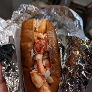 a lobster roll wrapped in foil