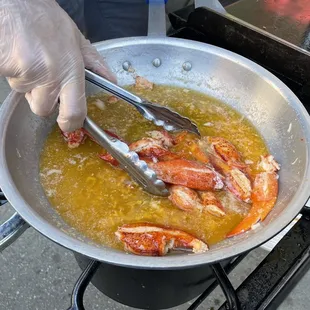a frying pan with lobsters