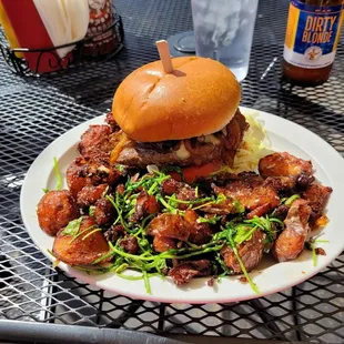 Bachelor One Burger with Blue Cheese, Caramelized Onions, Lettuce and Tomato on a Brioche Bun served with Roasted Red Skinned Potatoes