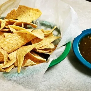 a bowl of chips and a bowl of salsa