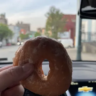 a hand holding a donut