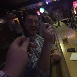 a man smiling and pointing at the camera