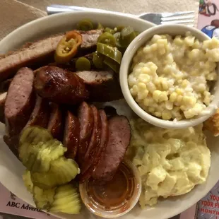 Three meat plate - pork ribs, jalapeno sausage, chicken - with corn pudding and potato salad.  Its a ton of food!