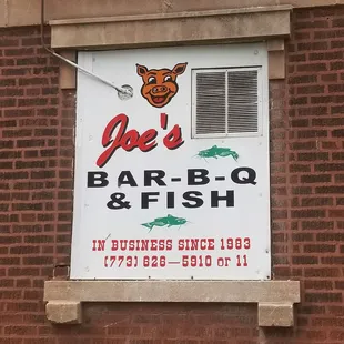 a sign on a brick building