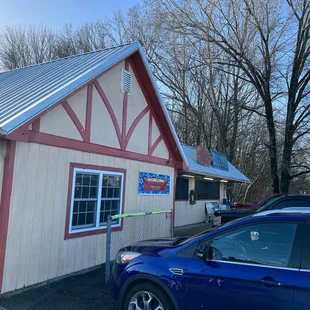 a blue car parked in front of the building