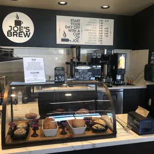 a coffee shop counter with a variety of pastries