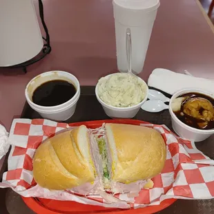 Ham and turkey sandwich with mashed potatoes and gravy, potato salad and Au jus dipping sauce.