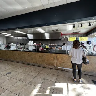 a woman standing in front of a counter