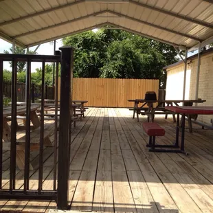 a patio with tables and benches