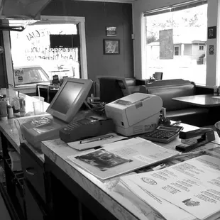 a desk with a computer and a printer