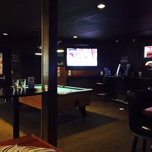 a pool table in a dimly lit room