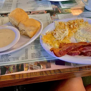 Eggs, bacon &amp; hash browns with biscuit and gravy.