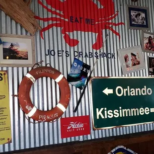 a wall of signs and a life preserver