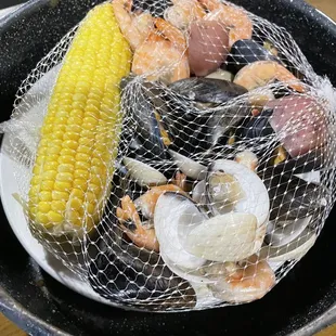 a plate of seafood and corn