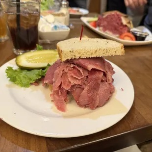 1/2 corned beef sandwich with bowl of soup