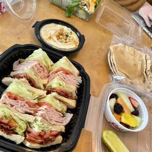 a table with sandwiches and fruit