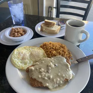 Chicken fried steak, perfectly prepared eggs, beans 'n rice, sourdough toast, and rich black coffee (before)