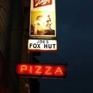 a neon sign for a pizza restaurant