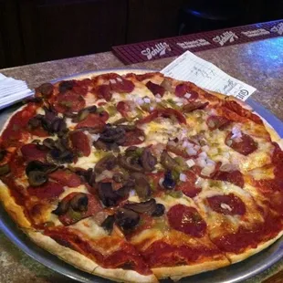 a pepperoni pizza on a pan