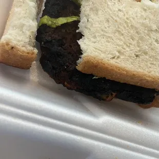 Completely burned patty with white bread as a bun