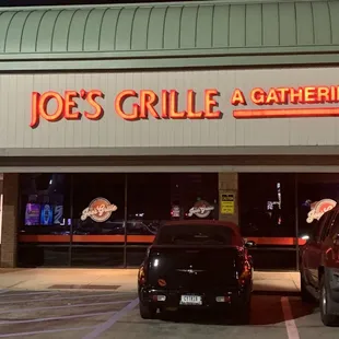 two cars parked in front of a restaurant