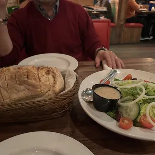 Large house salad and bread basket.