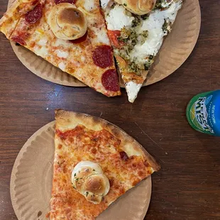 two slices of pizza on paper plates