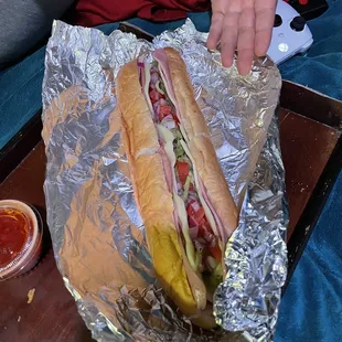 a sub sandwich wrapped in foil