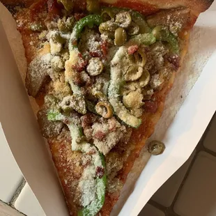 Slice with sausage, pepperoni, bacon, meatballs, green olives and green peppers