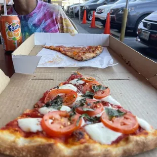 a slice of pizza in a box