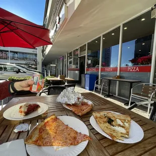 three slices of pizza on paper plates