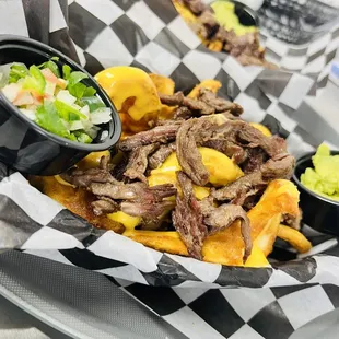 a plate of food with fries and guacamole