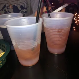 two plastic cups on a table