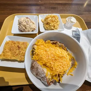 My meal: a massive baked potato with cheese, butter, and sour cream, cornbread with honey butter, potato salad, and Mac and cheese!