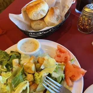 Salad, creamy italian dressing and fresh garlic bread.