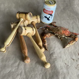 a crab, a crab claw, and a can of beer
