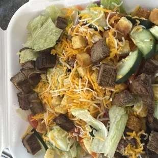 Sirloin Steak Salad that said romaine lettuce, but this is clearly iceberg. Asked for steak medium, got well done.