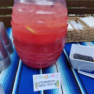 a pitcher of strawberry soda