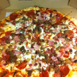 Meat pizza. Pepperoni, ham, salami, bacon, meatball, sausage (not pellets).