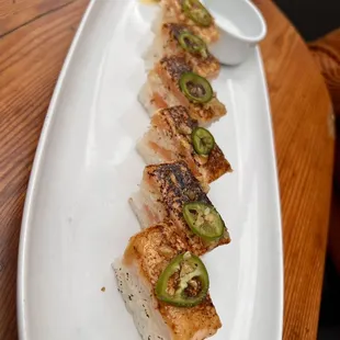 Seared salmon sushi with umami sauce and serrano peppers