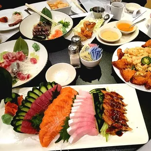 Sashimi plate, shrimp toast with fried squid, pan seared ahi tuna, tuna avocado sushi appetizer
