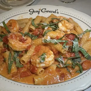 SHRIMP PASTA Sautéed shrimp, rigatoni pasta, roasted peppers, confit tomatoes, fresh basil, vodka tomato cream sauce