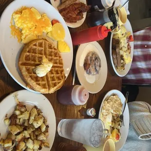 Waffle and eggs. Breakfast potatoes. Cinnamon roll. The colossal omelet