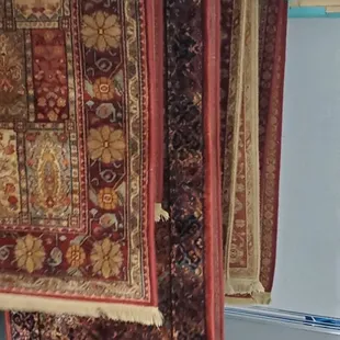 Wool rugs hanging to in our dry room after a full wash.