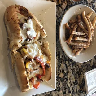 Sausage, peppers, onions, and cheese with fries