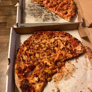 a half eaten pizza in a box
