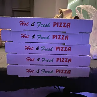 a stack of pizza boxes