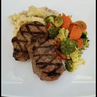 Filet Mignon: 2 hand trimmed 5oz medallions, chargrilled &amp; served with garlic whipped potatoes &amp; vegetables