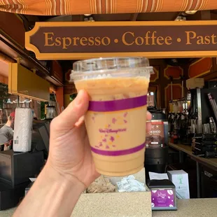 a hand holding a cup of coffee